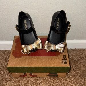 Mini Melissa Black Ballet Flats with Metallic Gold Bow